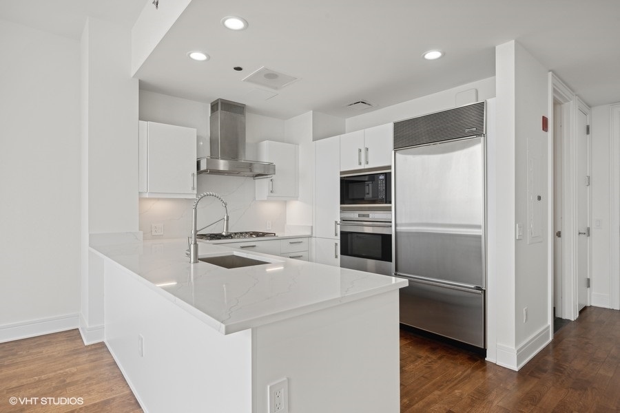 401 North Wabash Avenue, Unit 42E Chicago, IL 60611 - Photo 10 of 55 a kitchen that has a sink and stainless steel appliances