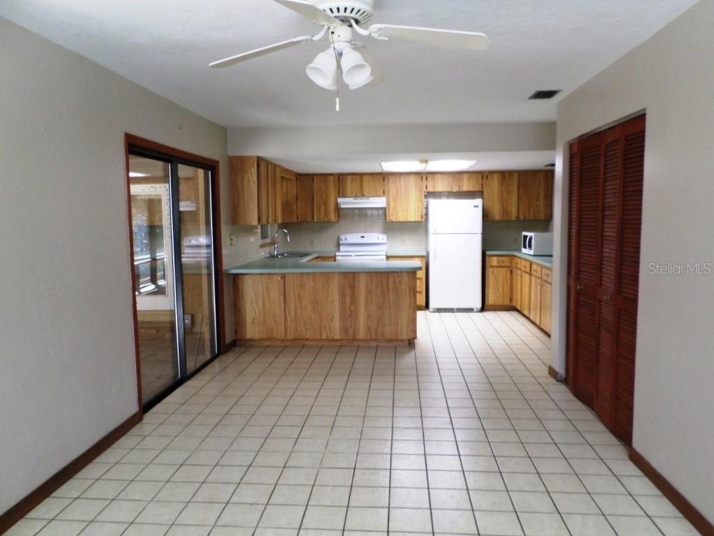 11606 Kennesaw Road Dunnellon, FL 34431 - Photo 15 of 33 a kitchen with stainless steel appliances a refrigerator and a stove top oven