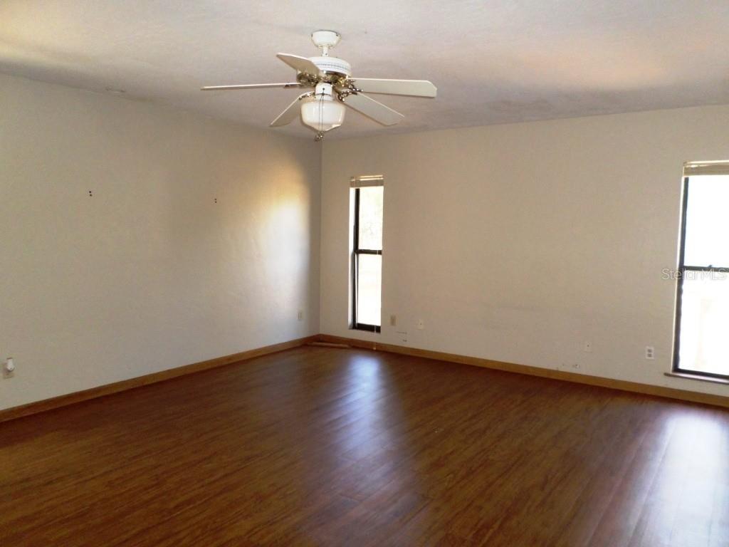 11606 Kennesaw Road Dunnellon, FL 34431 - Photo 17 of 33 a view of an empty room with wooden floor and a window
