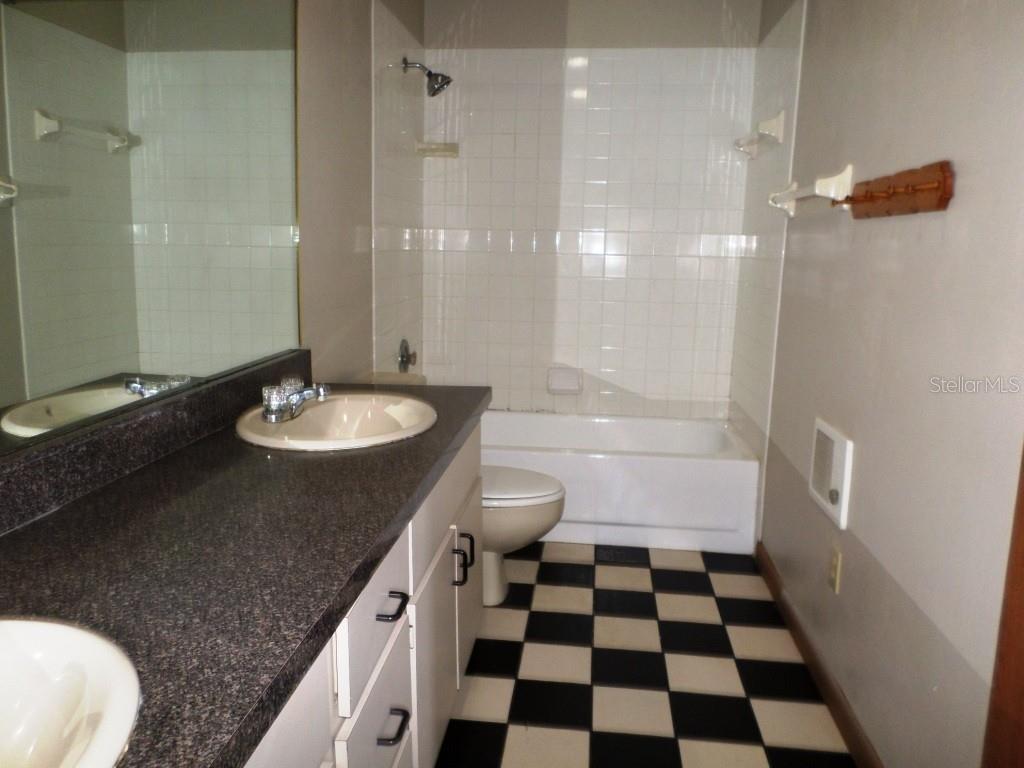 11606 Kennesaw Road Dunnellon, FL 34431 - Photo 20 of 33 a bathroom with a granite countertop sink and a mirror