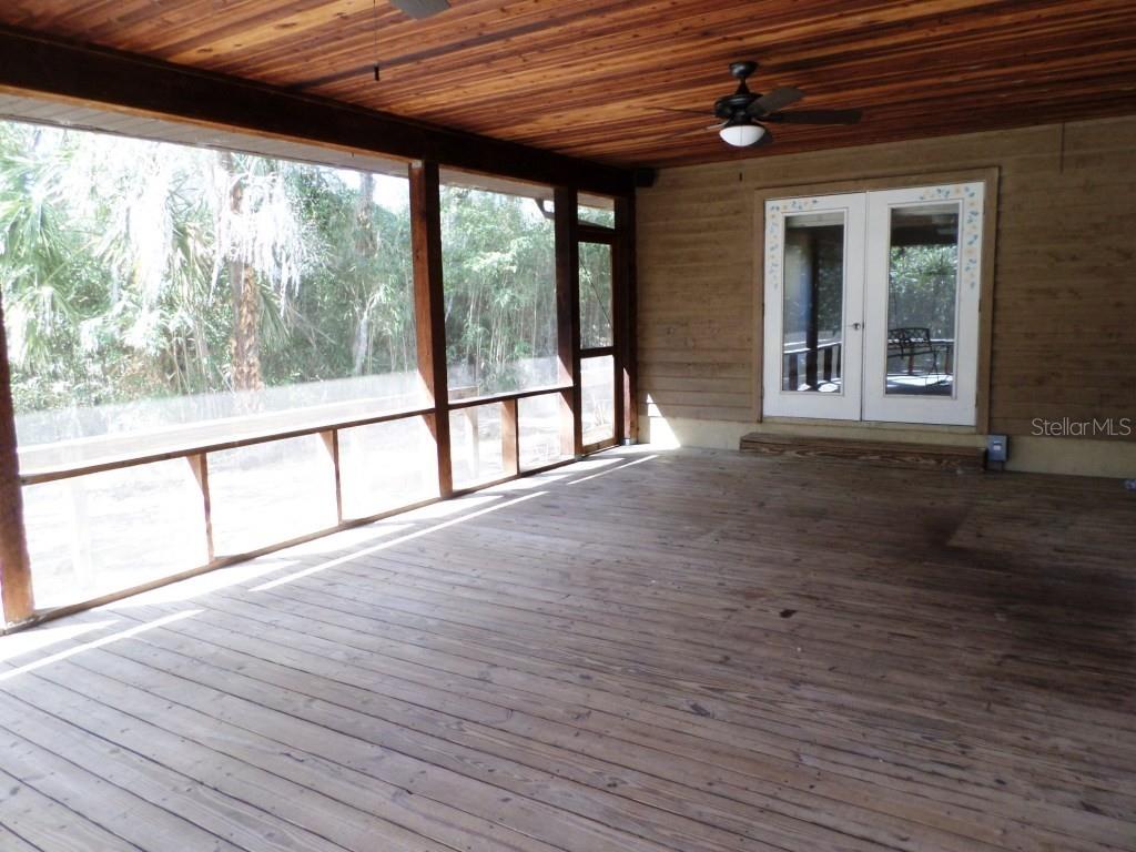 11606 Kennesaw Road Dunnellon, FL 34431 - Photo 24 of 33 a view of an empty room with wooden floor and a window