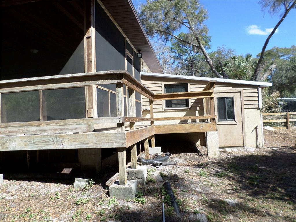 11606 Kennesaw Road Dunnellon, FL 34431 - Photo 27 of 33 a view of a house with a wooden deck