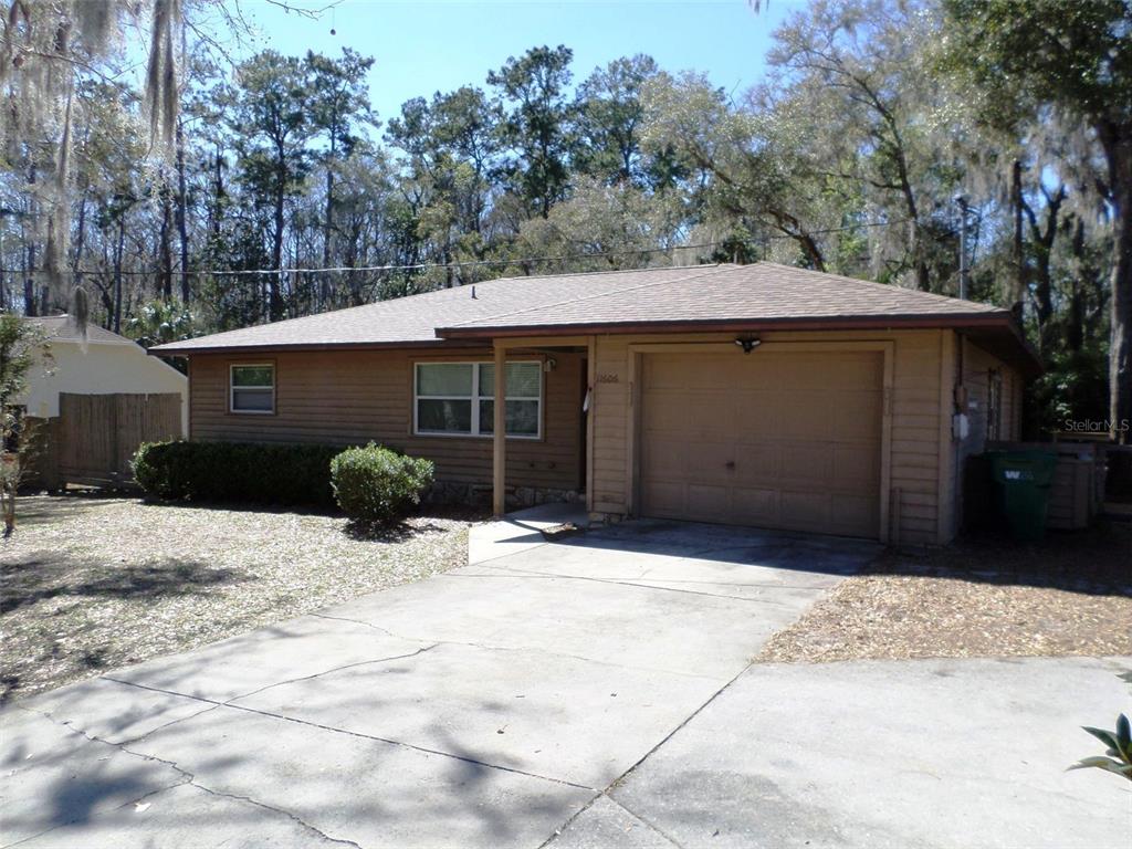 11606 Kennesaw Road Dunnellon, FL 34431 - Photo 3 of 33 a front view of a house with a yard and garage