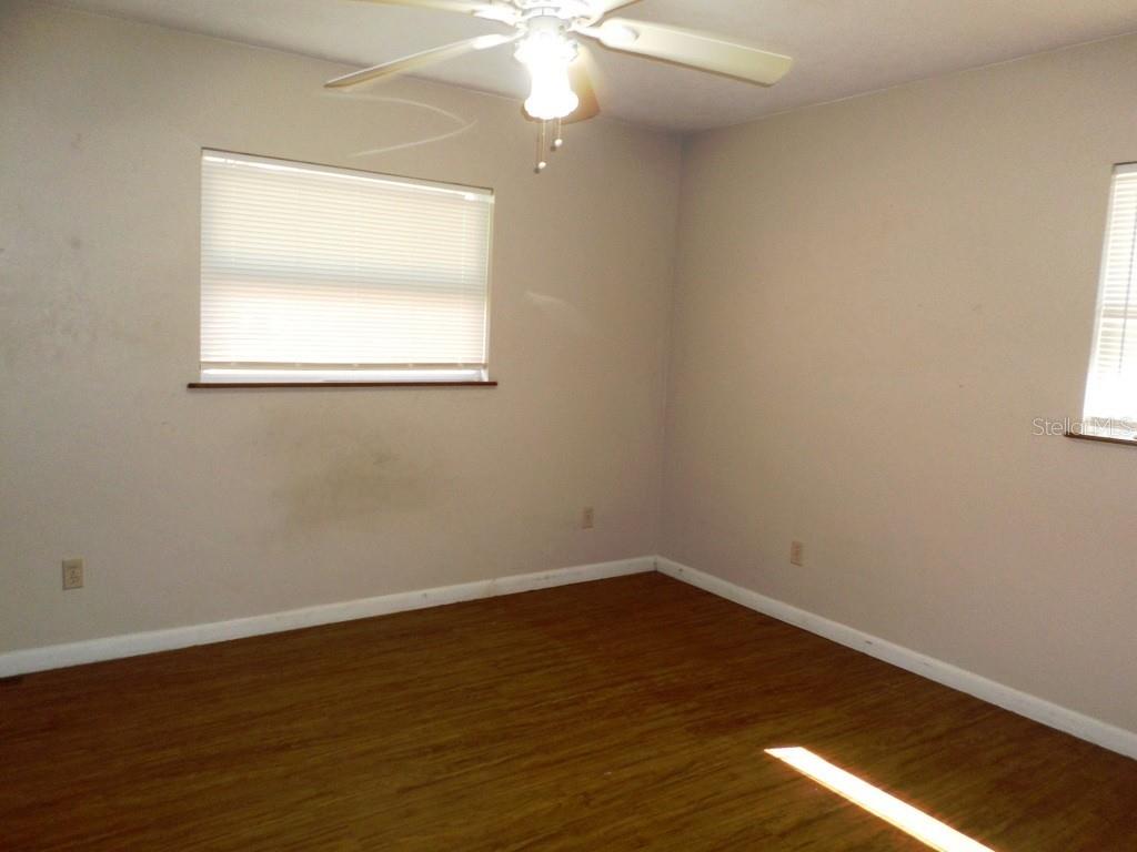 11606 Kennesaw Road Dunnellon, FL 34431 - Photo 7 of 33 a view of a room with wooden floor and windows