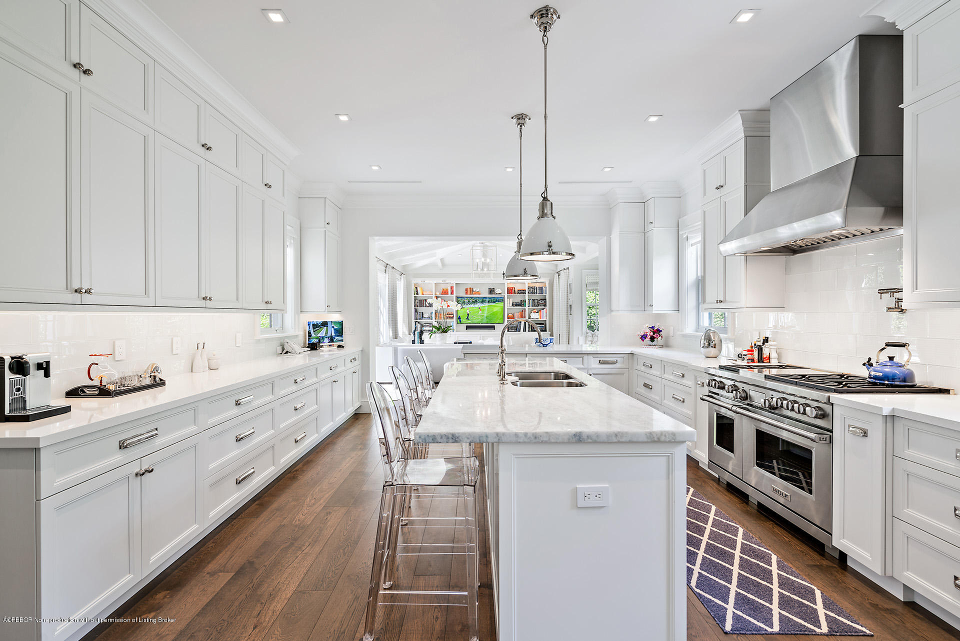 309 Dunbar Road Palm Beach, FL 33480 - Photo 11 of 24 a kitchen with kitchen island granite countertop a sink a stove and a wooden floors