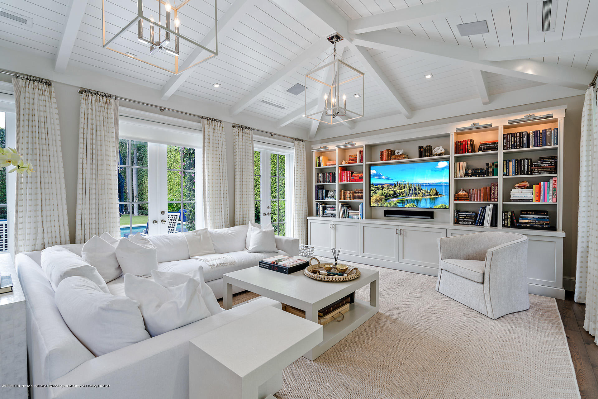 309 Dunbar Road Palm Beach, FL 33480 - Photo 12 of 24 a living room with furniture a flat screen tv and a large window