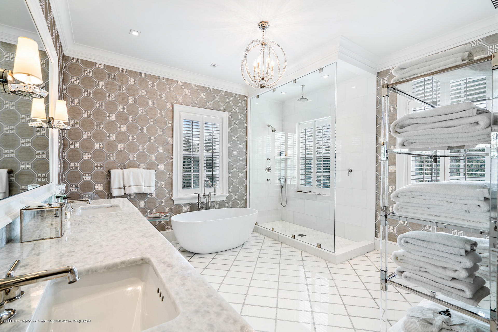 309 Dunbar Road Palm Beach, FL 33480 - Photo 17 of 24 a spacious bathroom with a tub shower and windows
