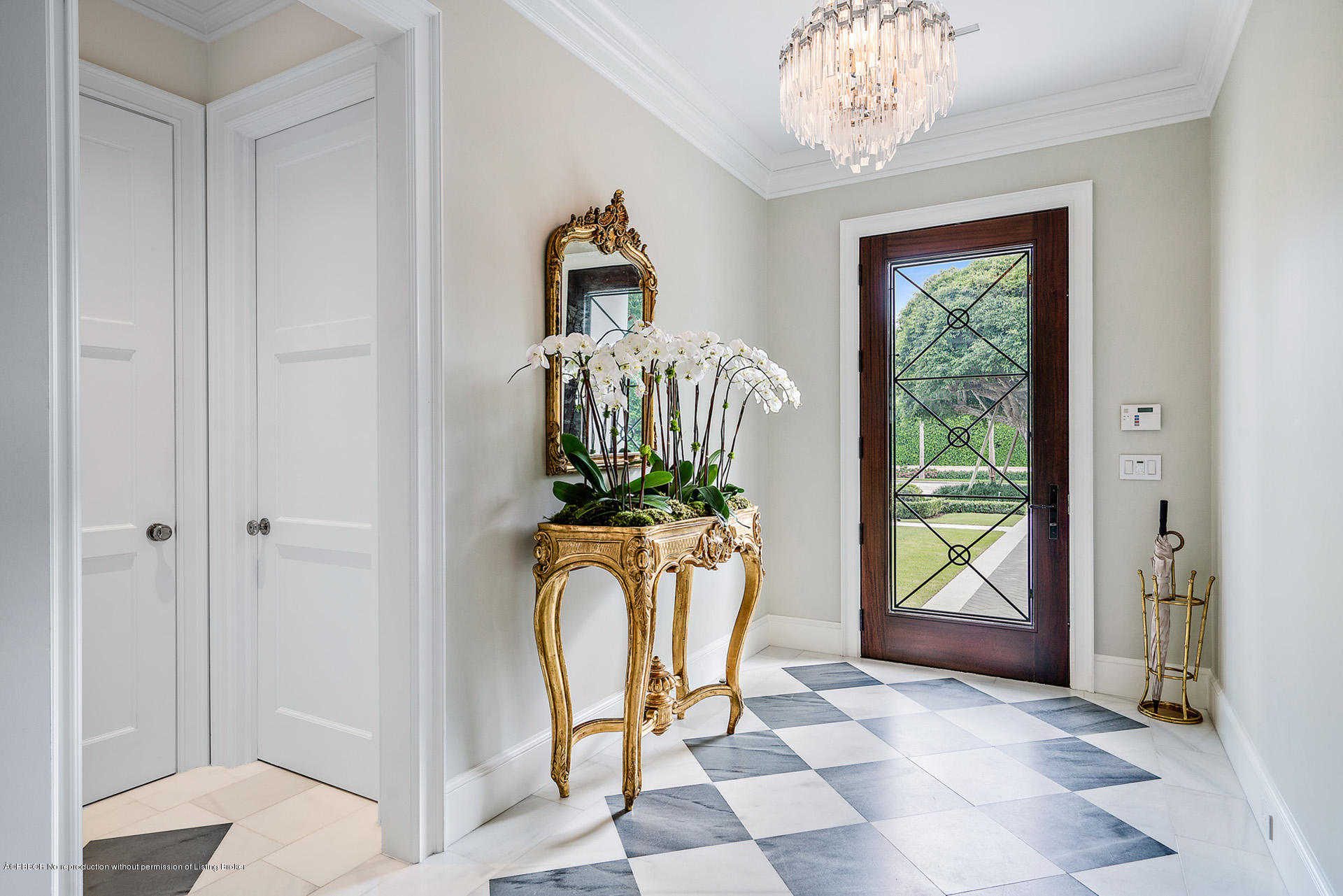 309 Dunbar Road Palm Beach, FL 33480 - Photo 3 of 24 a view of a hallway with windows and chandelier