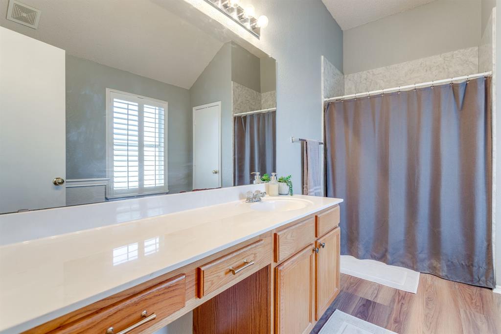 4816 Sleepy Ridge Circle Fort Worth, TX 76133 - Photo 24 of 36 Bathroom with vanity, light wood-type flooring, and vaulted ceiling