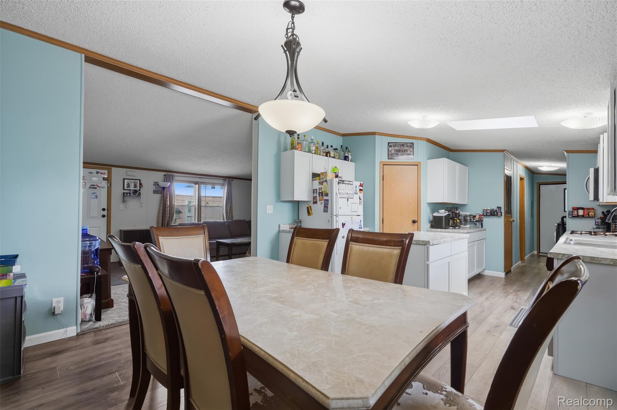 4634 Butternut Street Clarkston, MI 48348 - Photo 11 of 28 Dining area featuring a central chandelier and wood-finish flooring