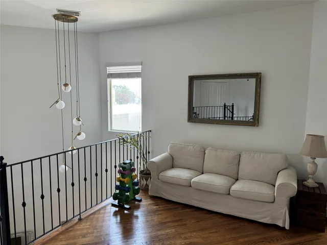 a bedroom with bed window and flat screen tv