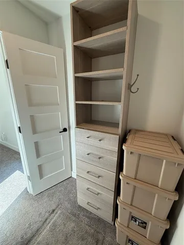 an empty room with a fireplace and window