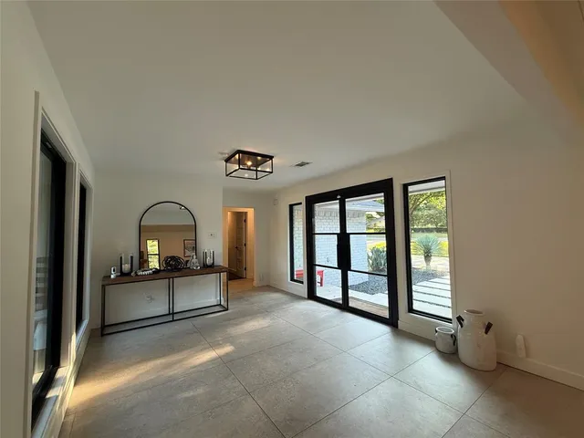 a large living room with kitchen island furniture and a window