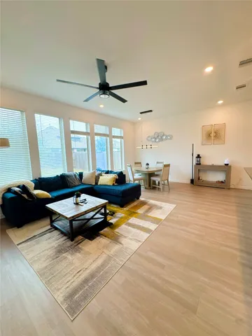 a living room with furniture gym equipment and a large window
