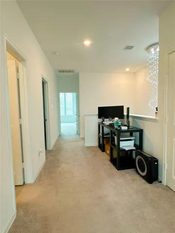 a view of a livingroom with workspace and a window