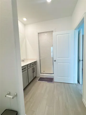 an empty room with a cabinet and mirrors