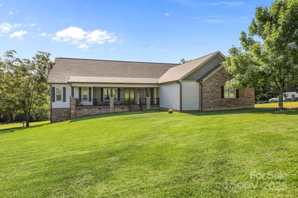 a view of a house with a backyard