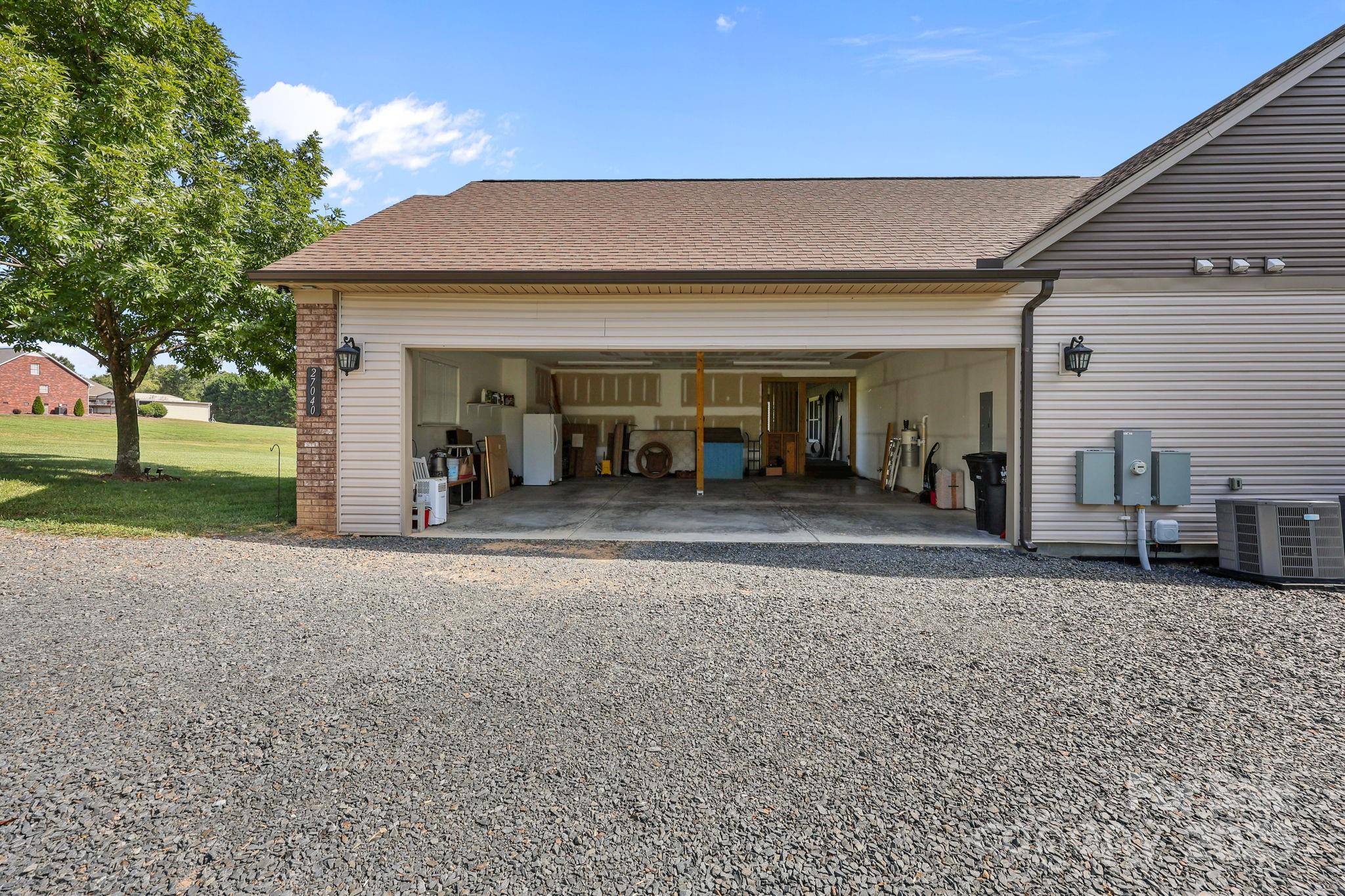 27040 Crepts Branch Road Locust, NC 28097 - Photo 14 of 48 a view of a house with a patio