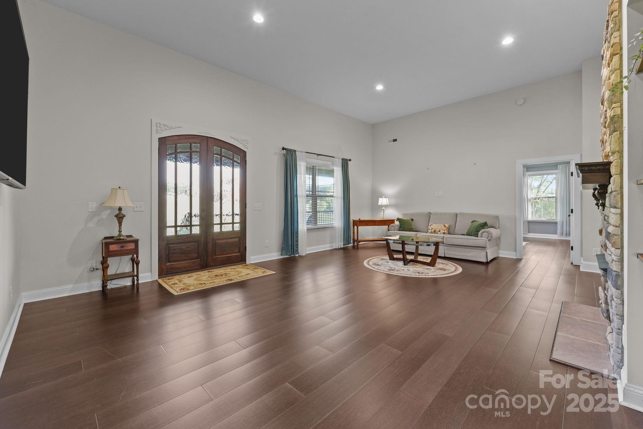 27040 Crepts Branch Road Locust, NC 28097 - Photo 19 of 48 a view of a livingroom with furniture and a floor to ceiling window