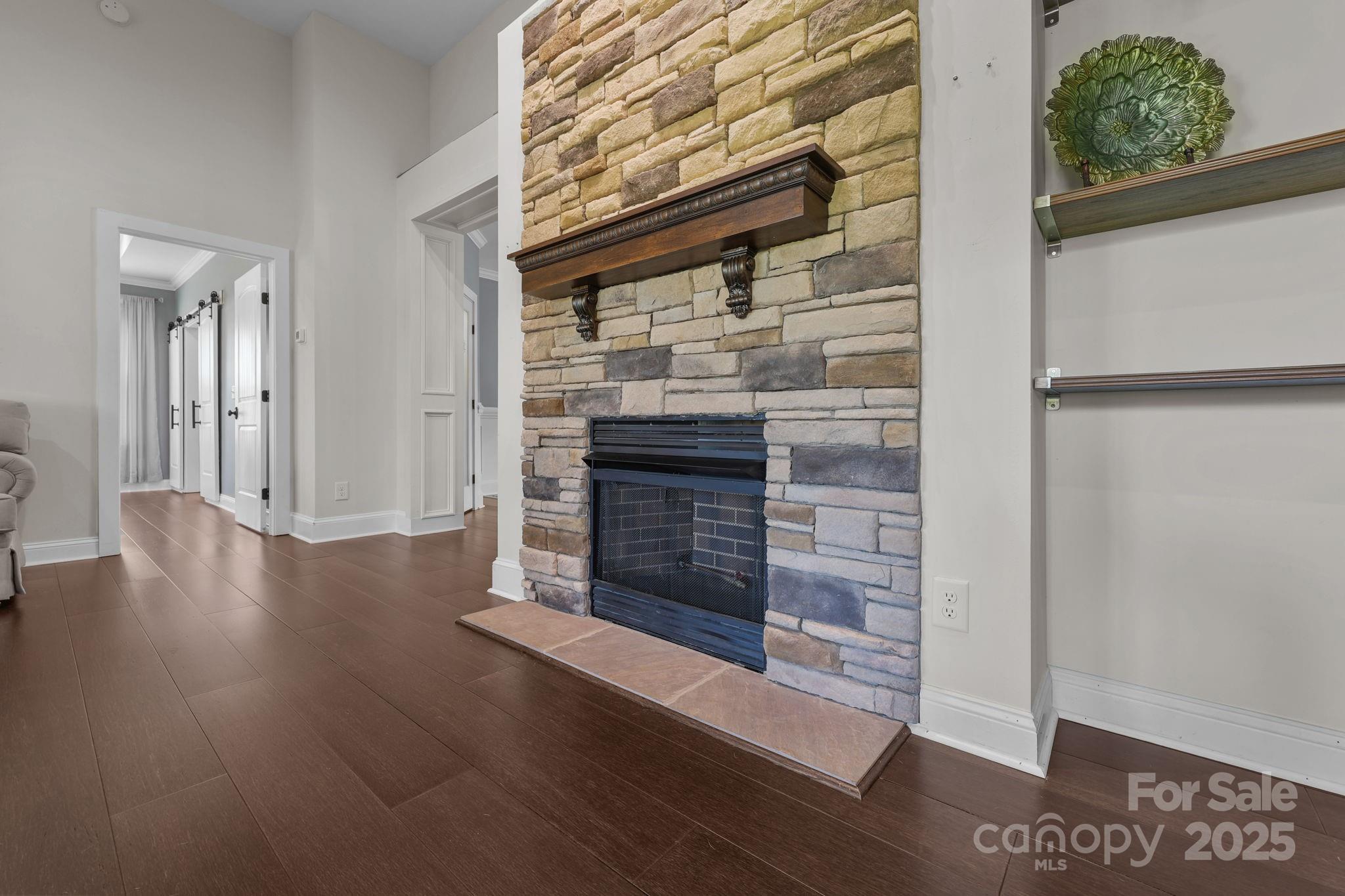 27040 Crepts Branch Road Locust, NC 28097 - Photo 21 of 48 a view of a hallway with wooden floor a fireplace and entryway