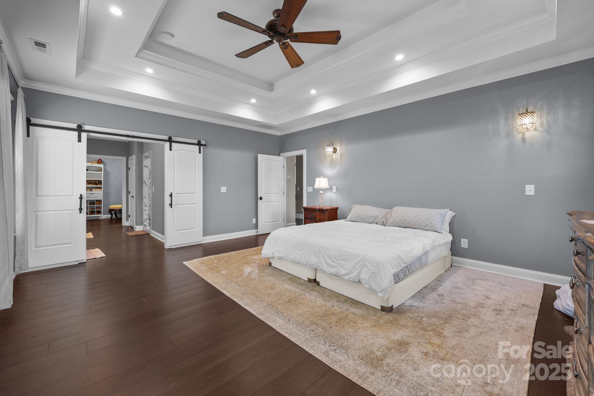 27040 Crepts Branch Road Locust, NC 28097 - Photo 24 of 48 a spacious bedroom with a bed and wooden floor
