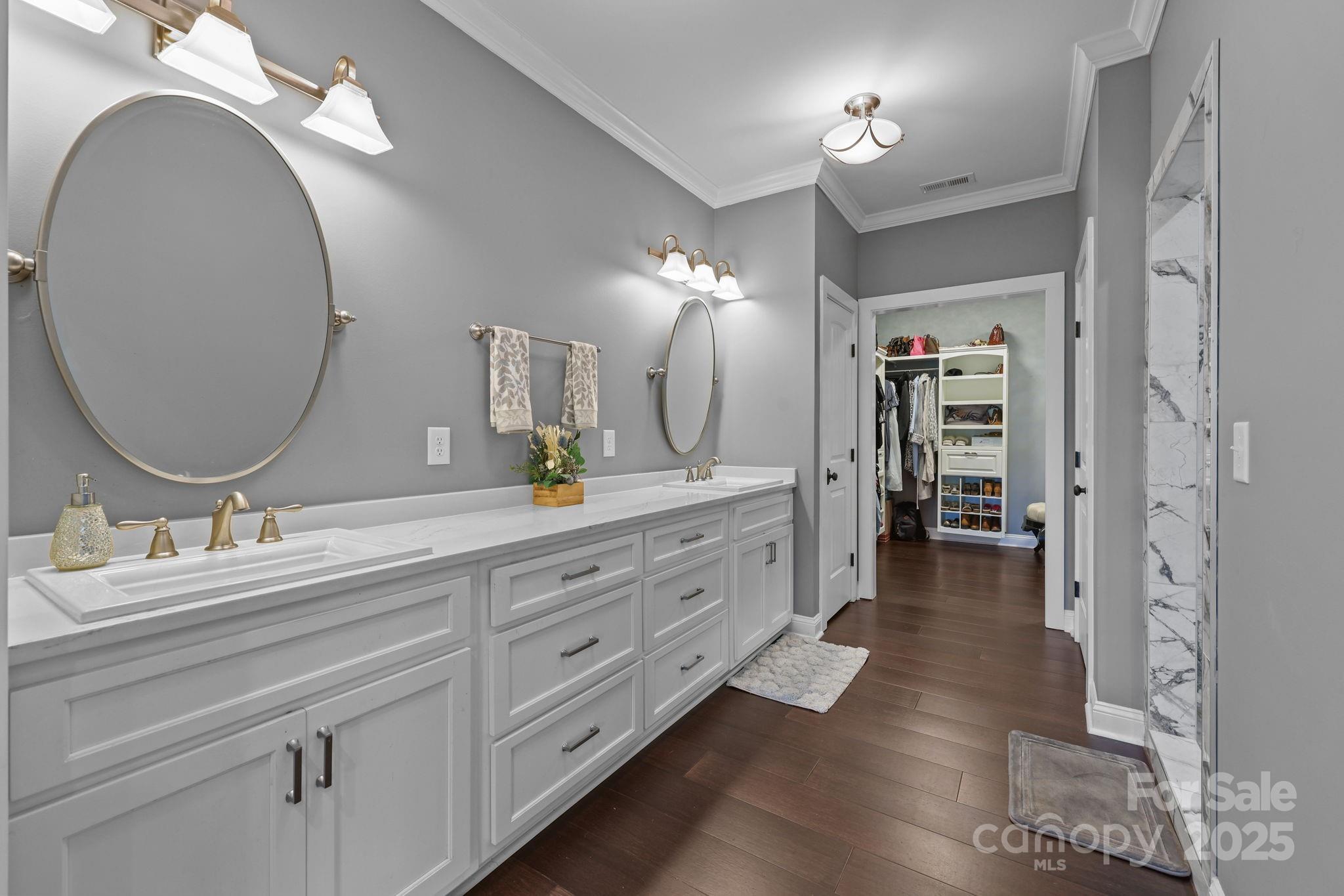 27040 Crepts Branch Road Locust, NC 28097 - Photo 25 of 48 a bathroom with a double vanity sink and a mirror