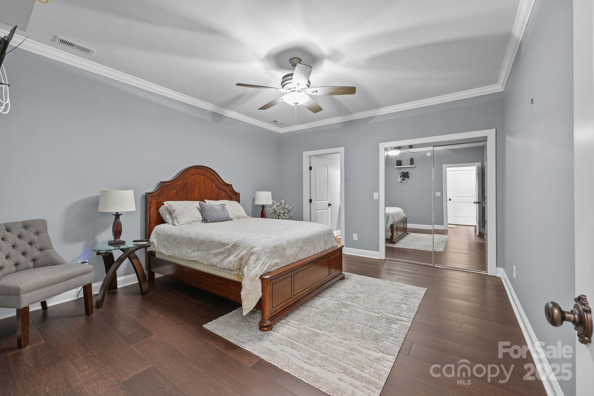 27040 Crepts Branch Road Locust, NC 28097 - Photo 36 of 48 a bedroom with a bed and a chandelier