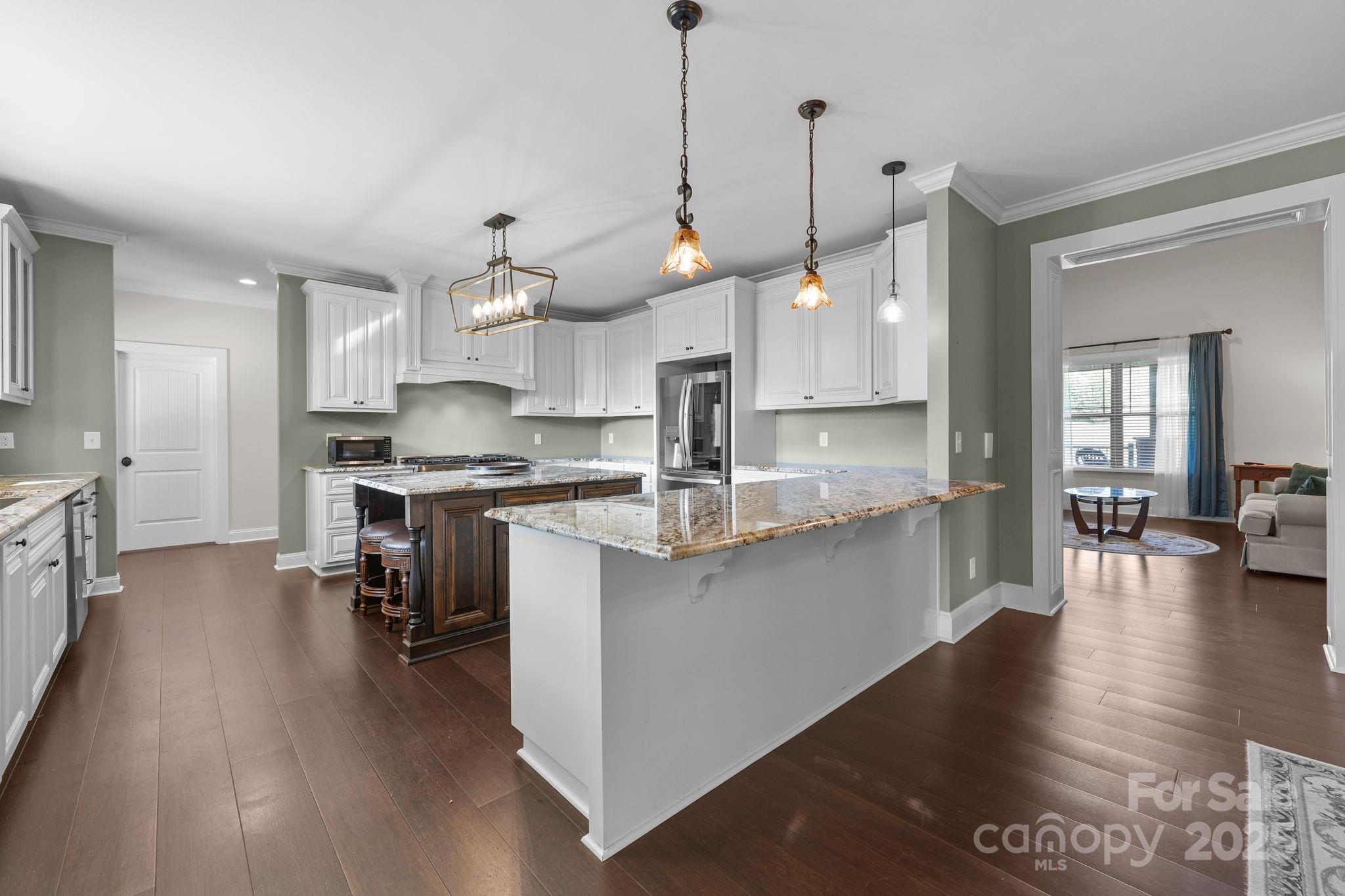 27040 Crepts Branch Road Locust, NC 28097 - Photo 39 of 48 a kitchen with stainless steel appliances kitchen island a large island in the center and cabinets