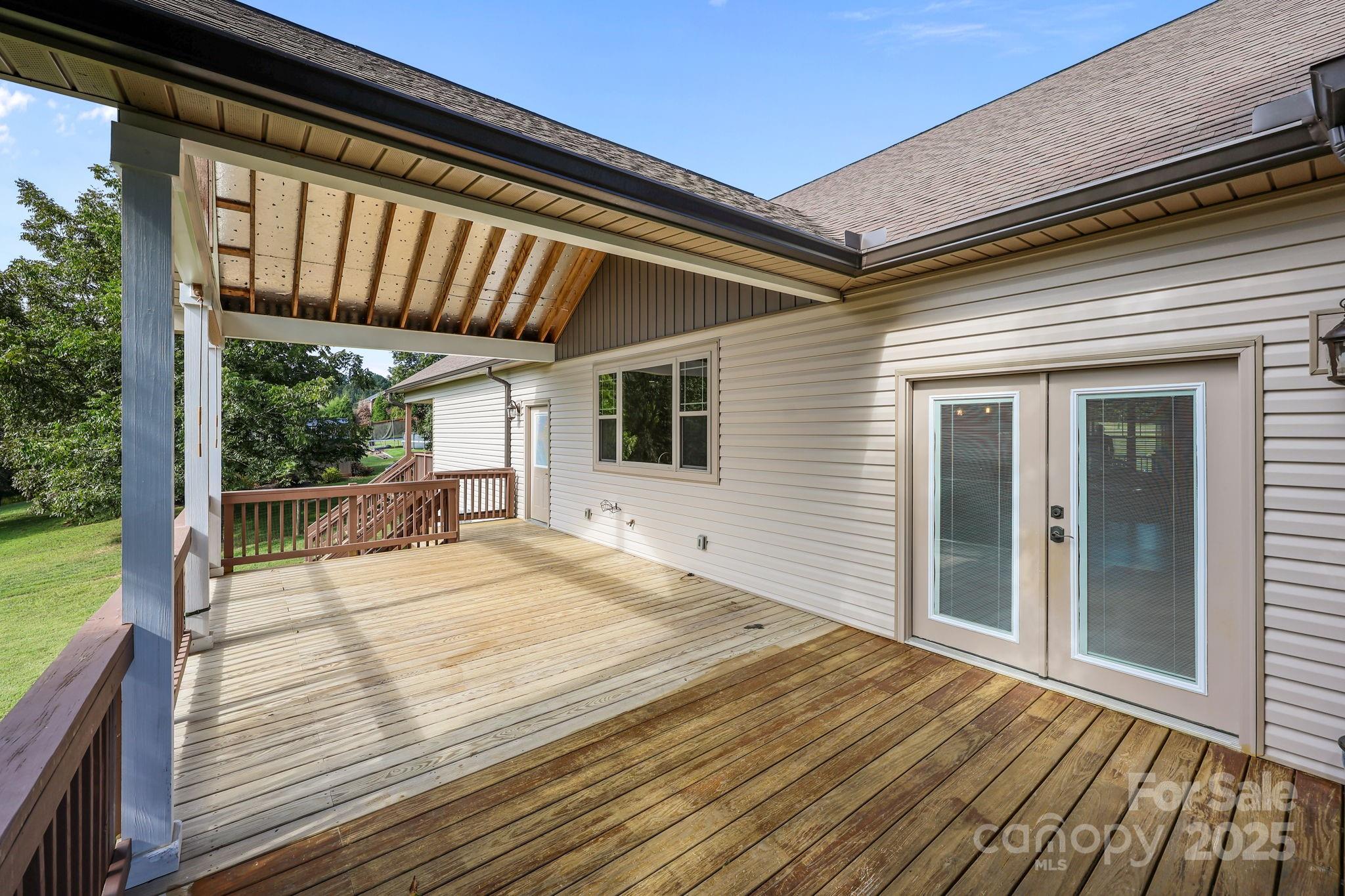27040 Crepts Branch Road Locust, NC 28097 - Photo 4 of 48 a patio with table and chairs and potted plants