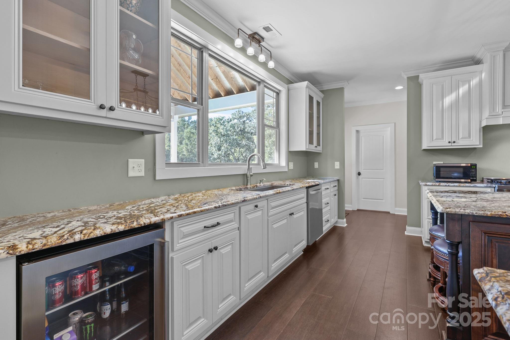 27040 Crepts Branch Road Locust, NC 28097 - Photo 41 of 48 a kitchen with stainless steel appliances granite countertop a stove a sink dishwasher and a microwave oven with white cabinets