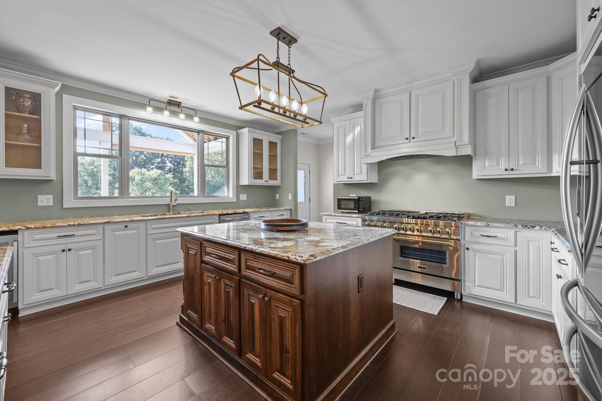 27040 Crepts Branch Road Locust, NC 28097 - Photo 42 of 48 a kitchen with granite countertop a sink stove and cabinets