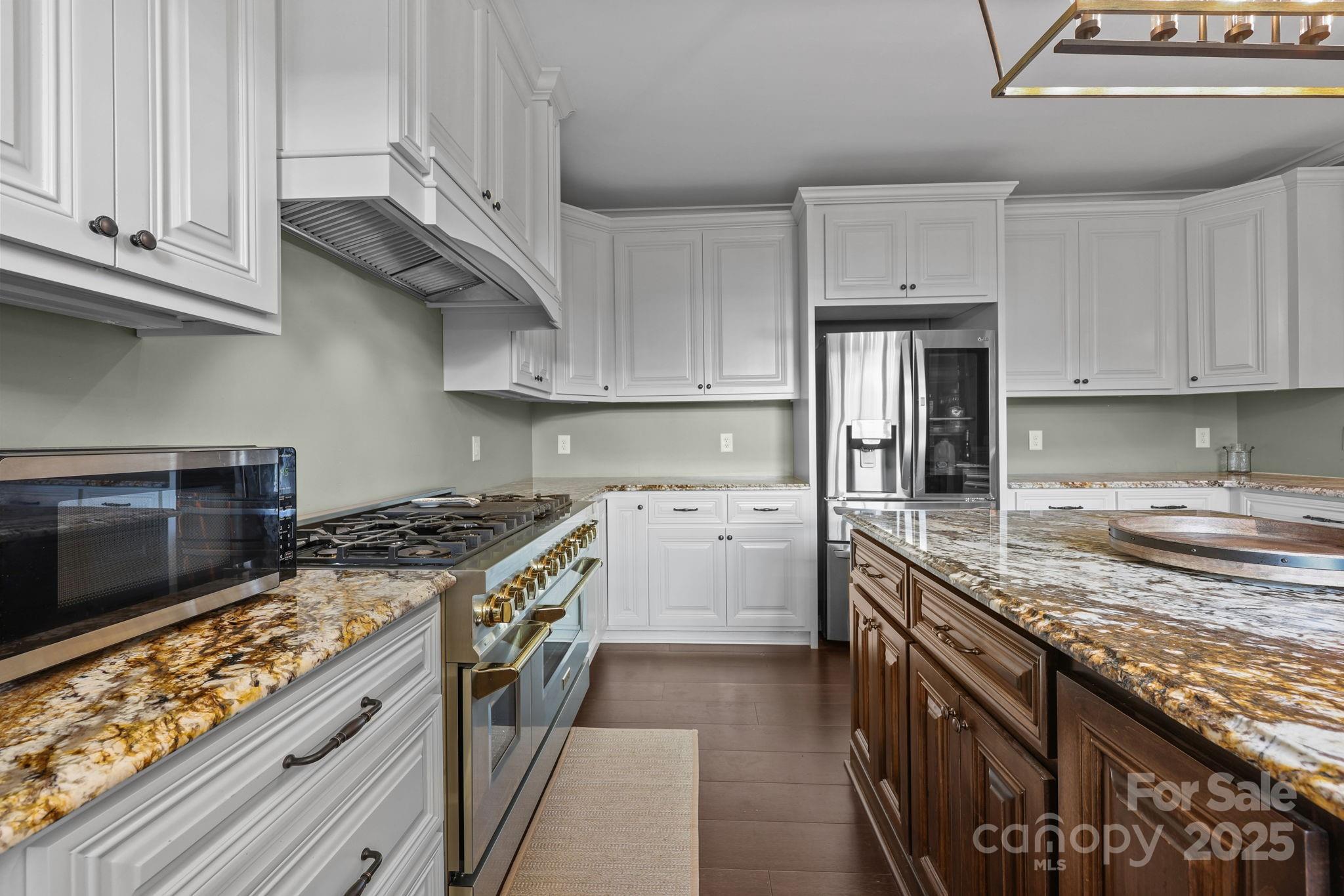 27040 Crepts Branch Road Locust, NC 28097 - Photo 43 of 48 a kitchen with stainless steel appliances granite countertop a stove a sink and a microwave