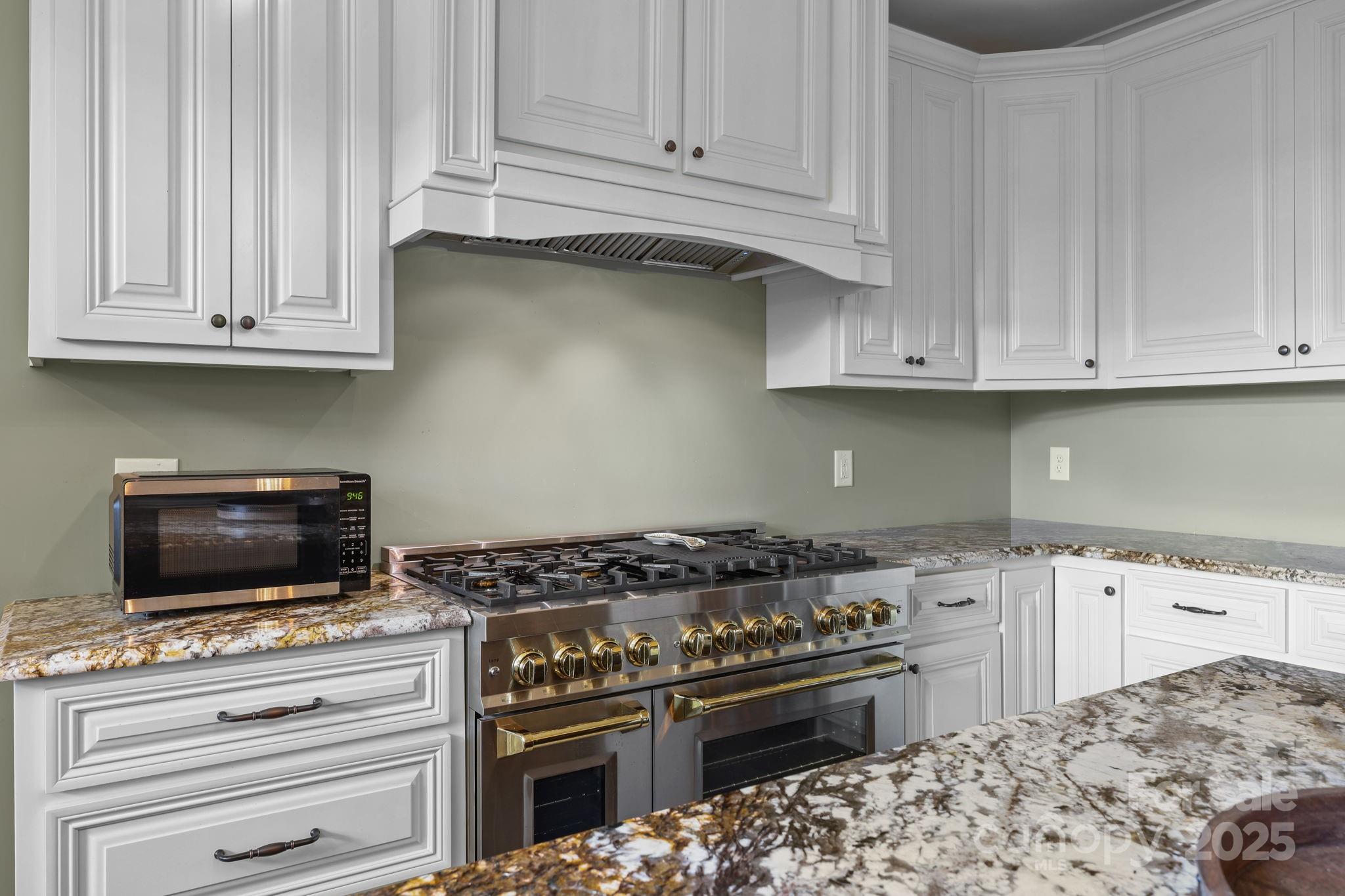 27040 Crepts Branch Road Locust, NC 28097 - Photo 44 of 48 a kitchen with granite countertop cabinets and steel stainless steel appliances
