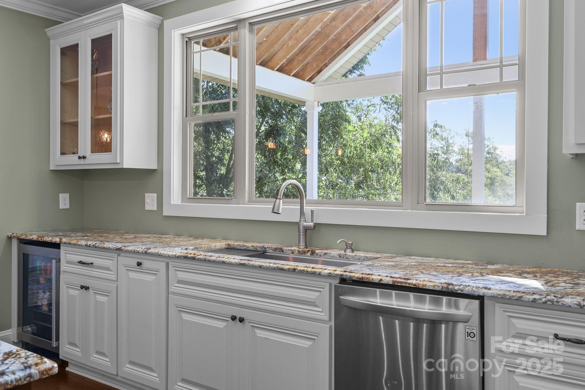 27040 Crepts Branch Road Locust, NC 28097 - Photo 45 of 48 a kitchen with granite countertop a window sink and cabinets