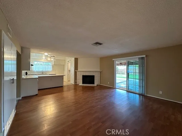 a view of a kitchen with a sink stove cabinets and empty room