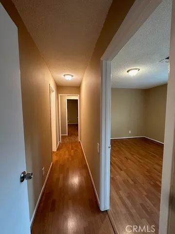 a view of hallway with wooden floor