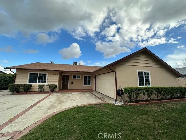 a view of house with yard and green space