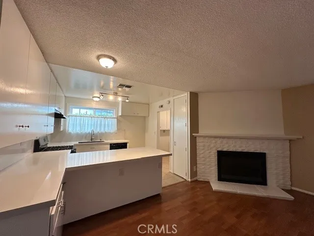 a large kitchen with a stove and a refrigerator
