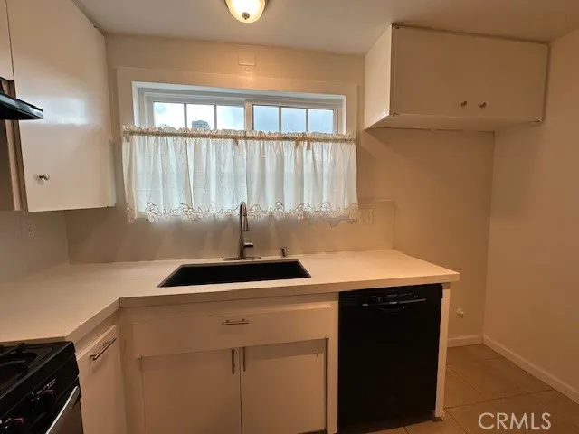a kitchen with a sink a stove and a window