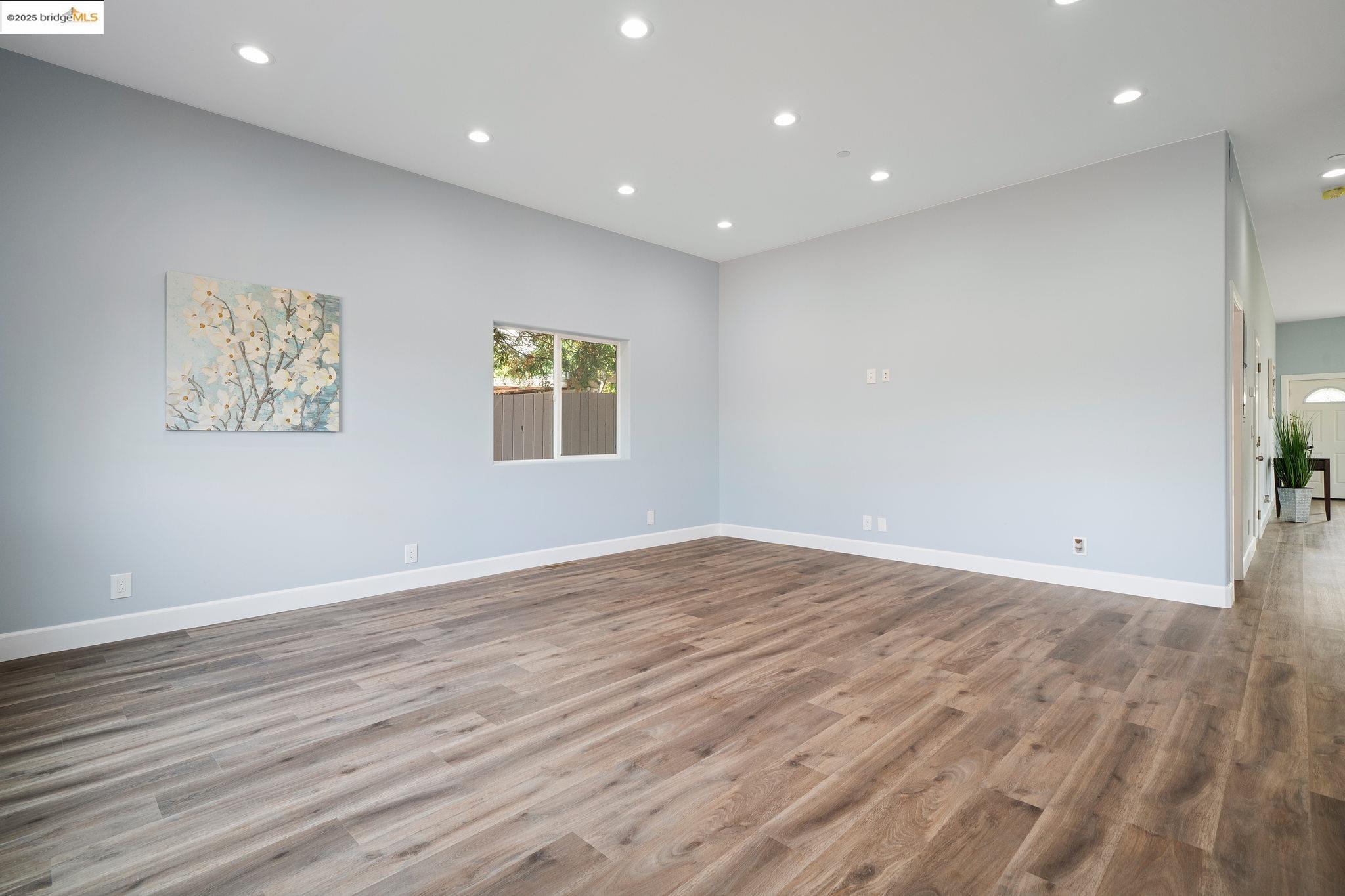 4511 Elmwood Road El Sobrante, CA 94803 - Photo 11 of 42 an empty room with wooden floor and window