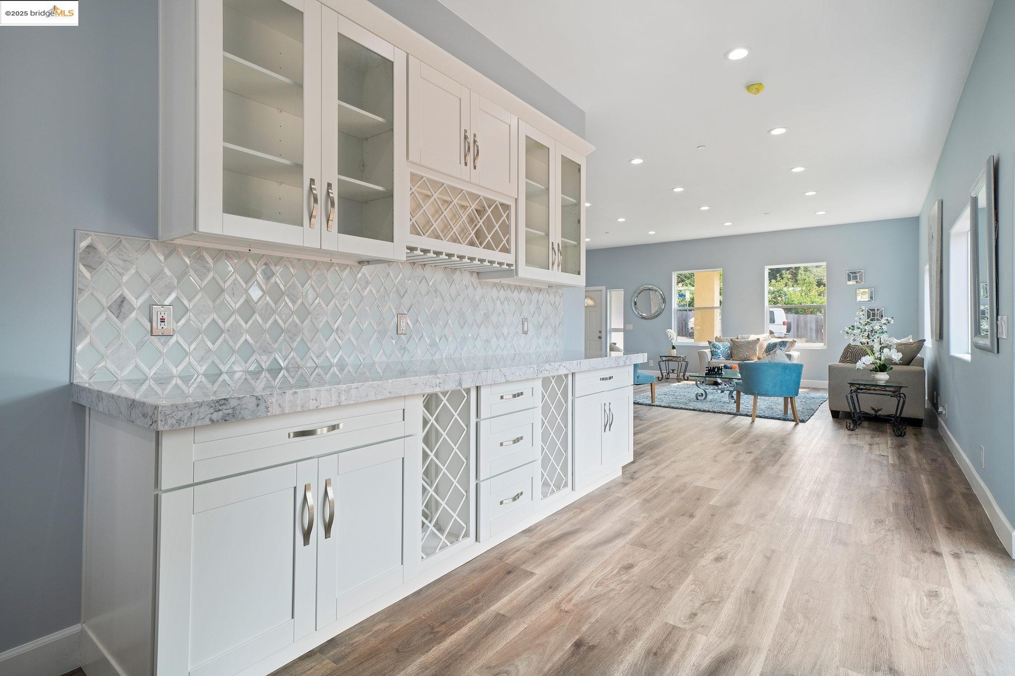4511 Elmwood Road El Sobrante, CA 94803 - Photo 12 of 42 a kitchen with granite countertop a sink cabinets and living room view