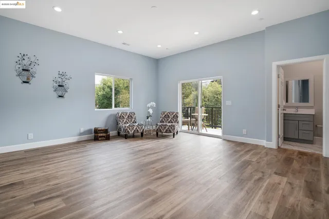 a view of a livingroom with furniture wooden floor and windows