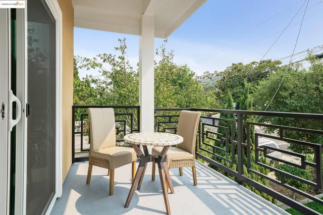 a view of a chairs and table in the balcony