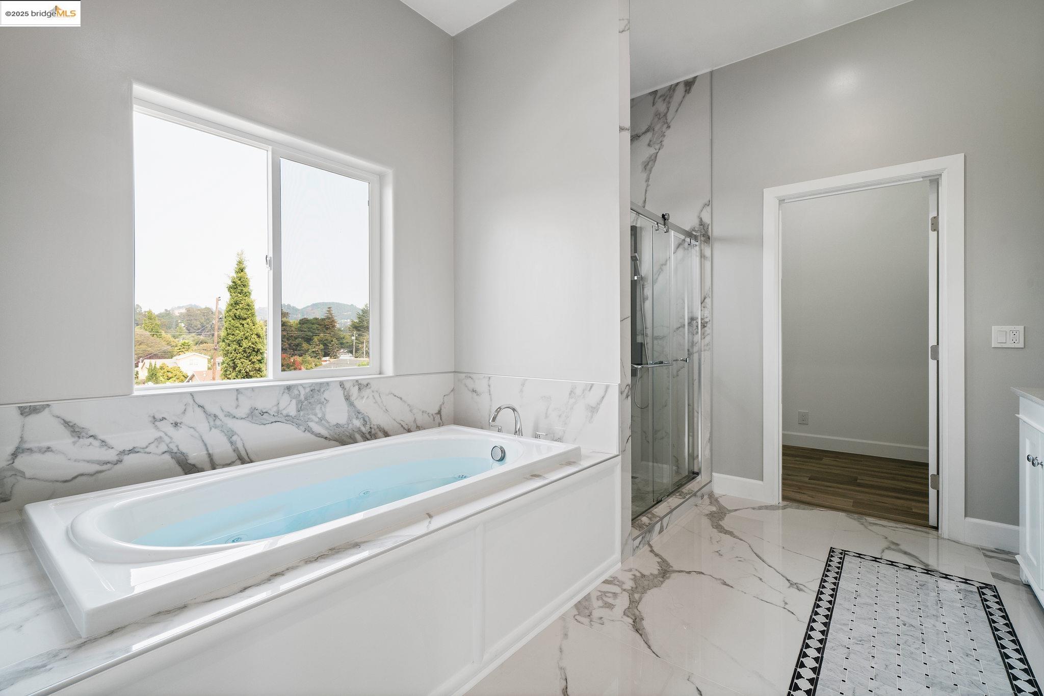 4511 Elmwood Road El Sobrante, CA 94803 - Photo 23 of 42 a bathroom with a tub sink and shower