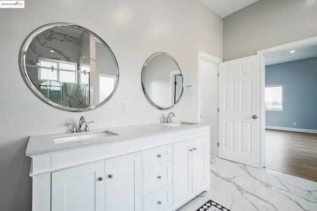 a bathroom with a double vanity sink and a mirror