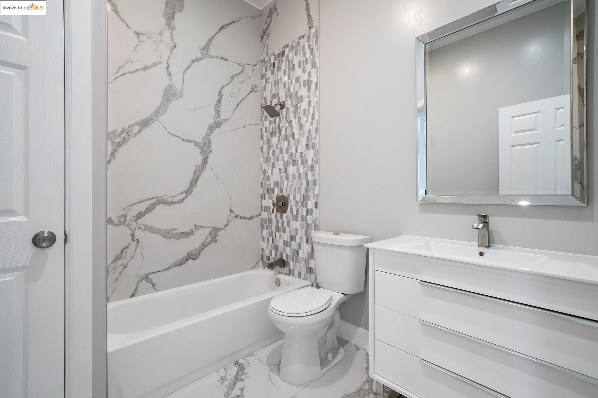 4511 Elmwood Road El Sobrante, CA 94803 - Photo 26 of 42 a bathroom with a toilet sink vanity tub and shower