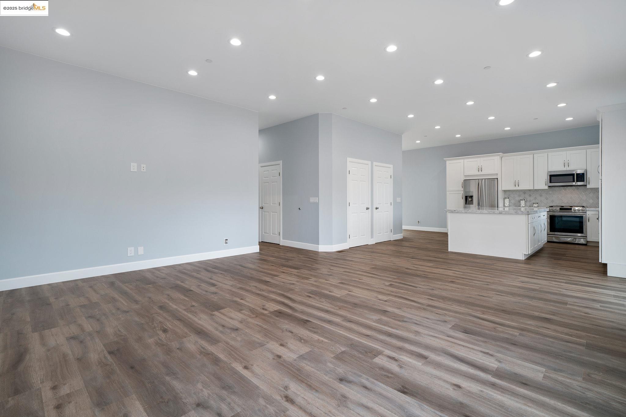 4511 Elmwood Road El Sobrante, CA 94803 - Photo 10 of 42 a view of kitchen with kitchen island wooden floor center island and stainless steel appliances