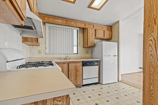 a kitchen with a stove a refrigerator and a sink