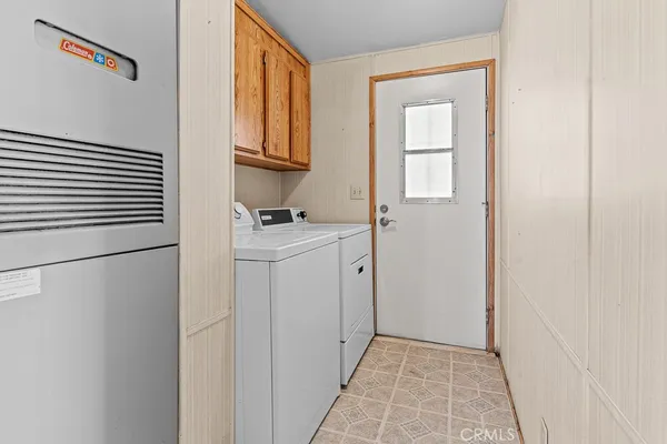 a view of a storage and utility room with washer and dryer