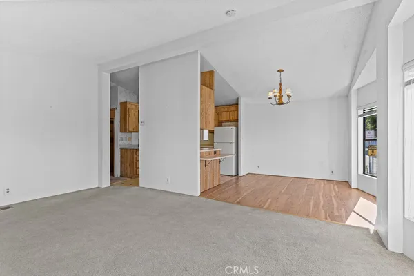 a view of an empty room with window and stairs